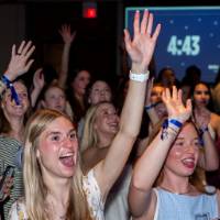 Grads cheer and raise hands at Toast